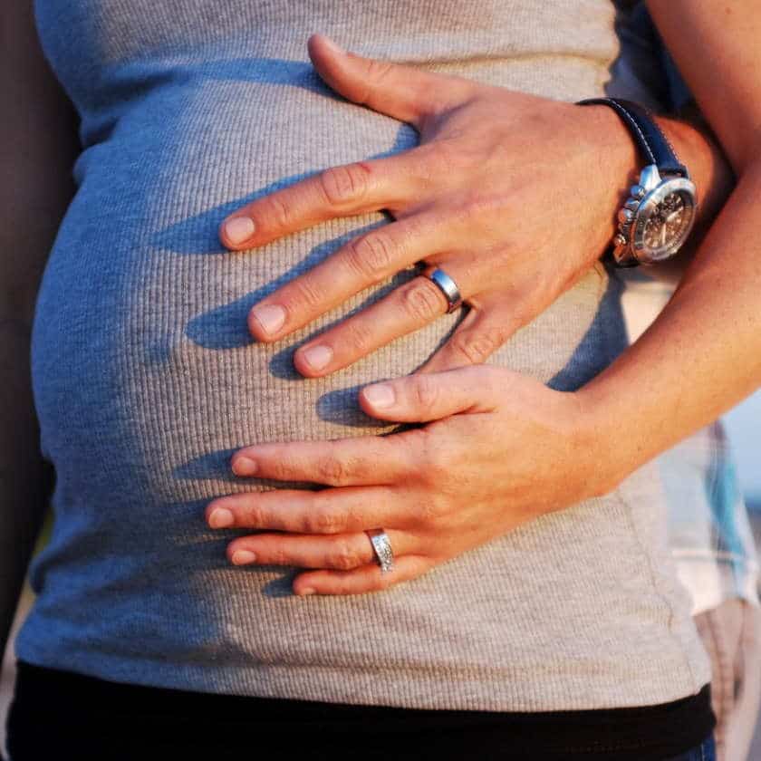 Hands gently cradling a pregnant belly, supported by gentle chiropractic care at Farrelly Chiropractic Narre Warren