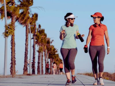 Walking for back pain relief two women on promenade
