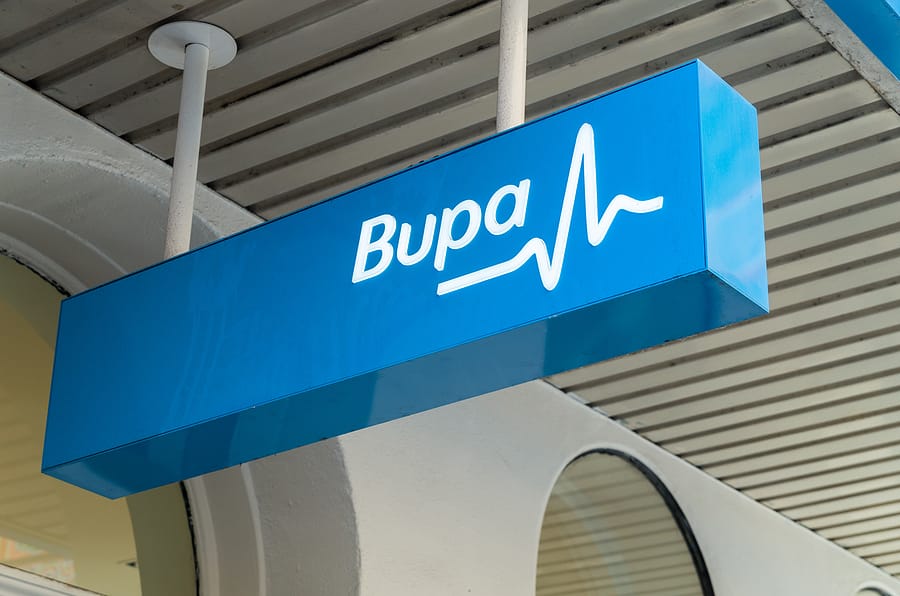 a bupa sign hanging outside an office